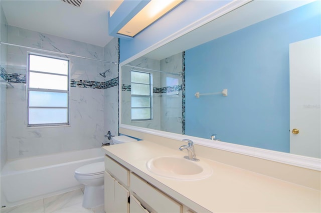 full bathroom with toilet, tiled shower / bath combo, vanity, and tile patterned floors