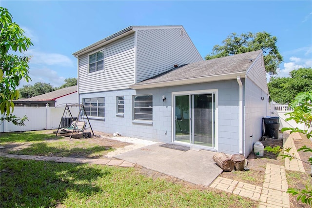 rear view of property with a patio area and a yard