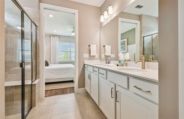 bathroom with ceiling fan, vanity, tile patterned flooring, and a shower with door