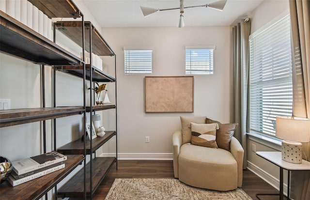 living area with ceiling fan and dark hardwood / wood-style floors