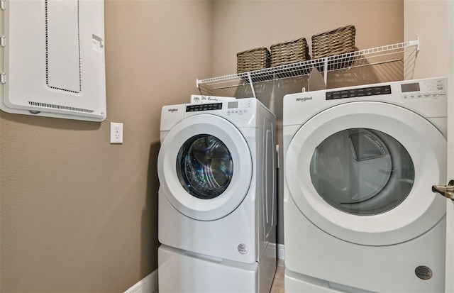 laundry room featuring washing machine and clothes dryer and tile patterned floors