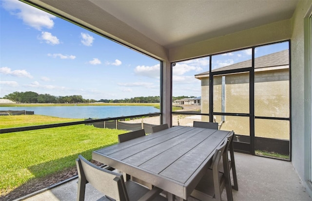 sunroom / solarium with a water view