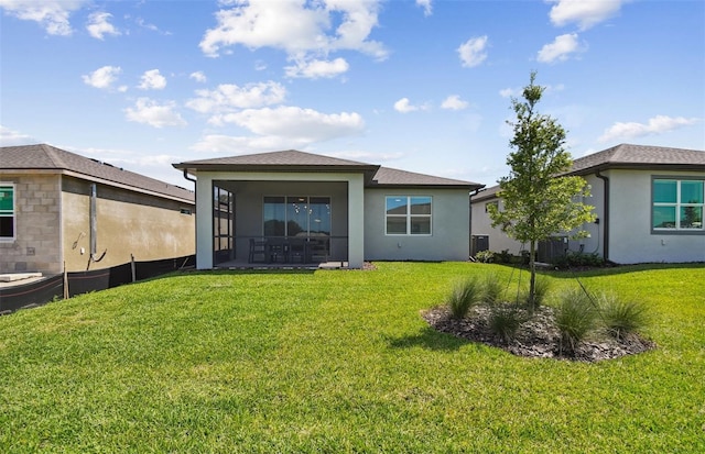 rear view of house with a lawn and a patio