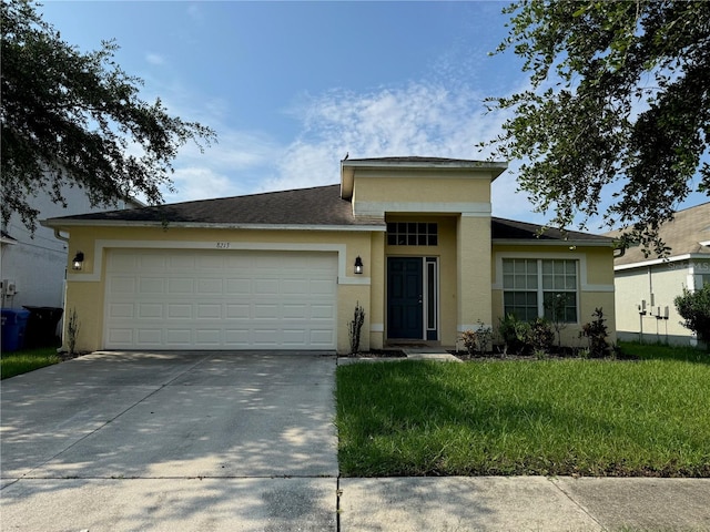 view of front facade with a front yard and a garage