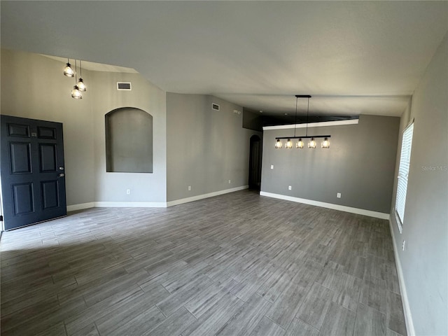 interior space featuring hardwood / wood-style floors and lofted ceiling