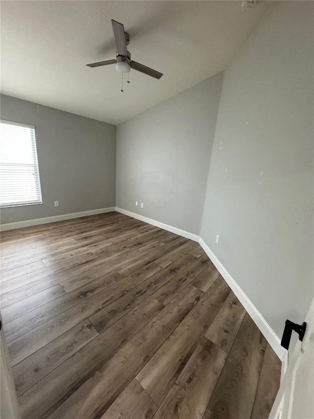 empty room featuring hardwood / wood-style floors and ceiling fan