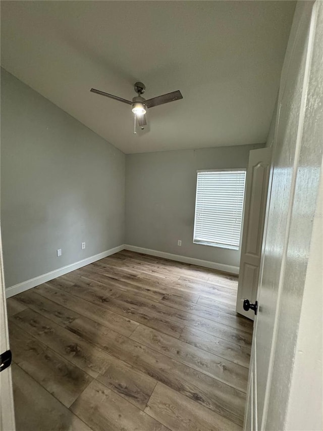 empty room featuring ceiling fan and light hardwood / wood-style flooring