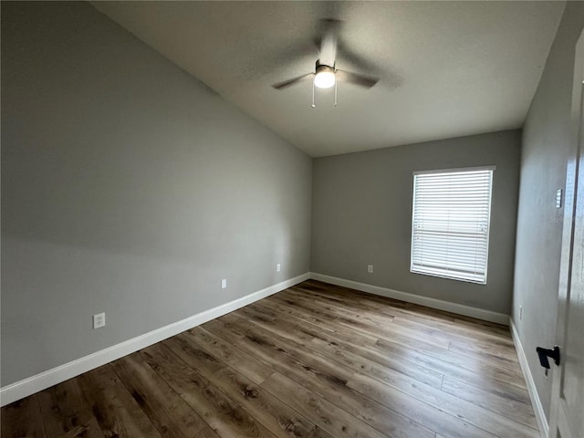 spare room featuring ceiling fan, vaulted ceiling, and hardwood / wood-style flooring