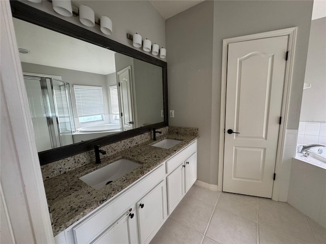 bathroom featuring dual vanity, tile patterned floors, and plus walk in shower