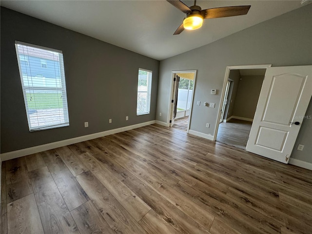 unfurnished bedroom with ceiling fan, vaulted ceiling, and hardwood / wood-style flooring