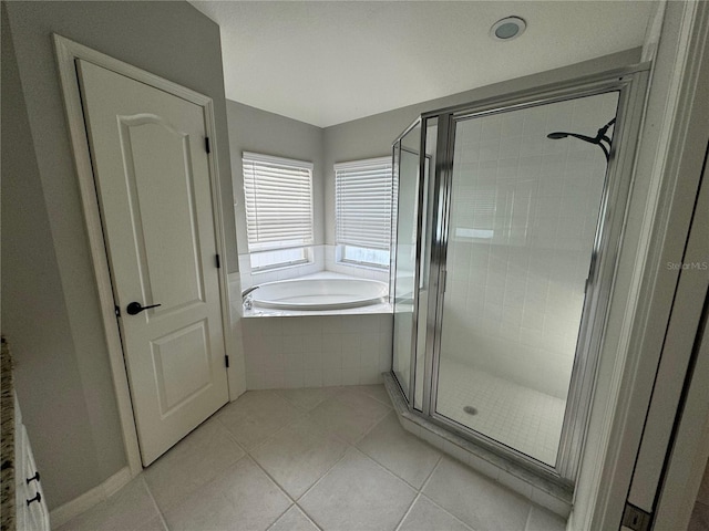 bathroom featuring tile patterned flooring and independent shower and bath