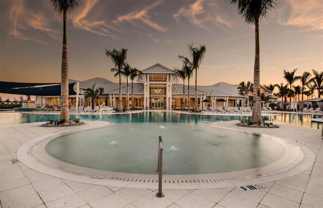 view of pool at dusk