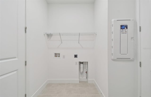 laundry room featuring electric dryer hookup, light tile patterned flooring, and washer hookup