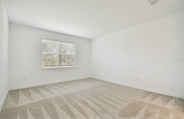 empty room featuring light carpet