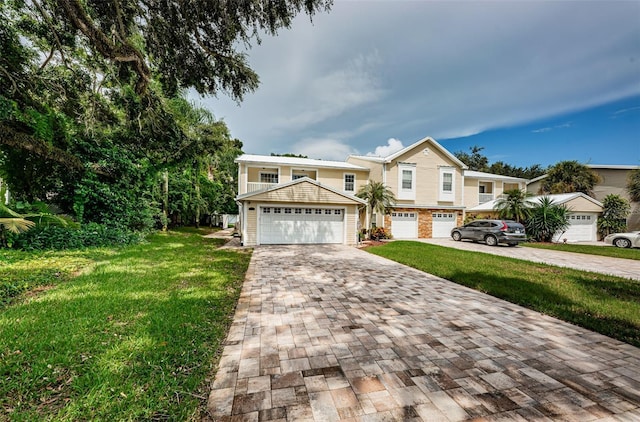 view of front of house featuring a garage and a front lawn