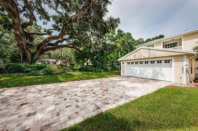 view of front of house featuring a garage and a front lawn