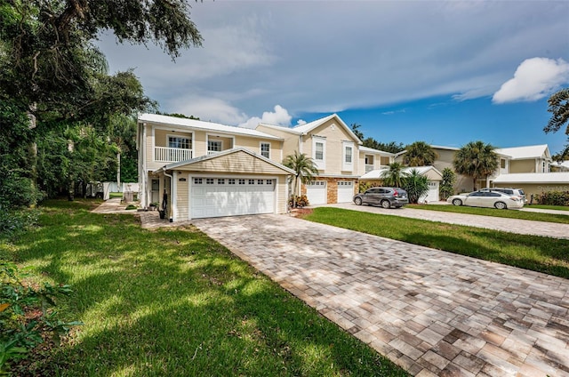 view of front of property with a garage, a balcony, and a front yard