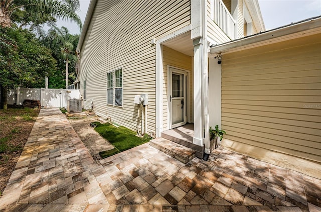 doorway to property with a patio and central AC unit