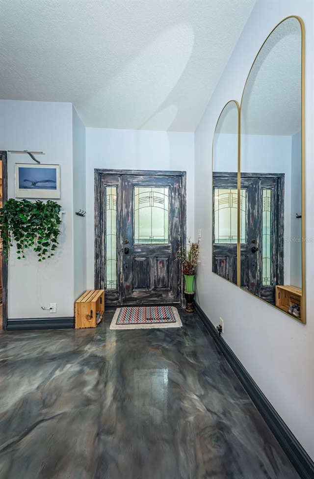 foyer entrance featuring a textured ceiling