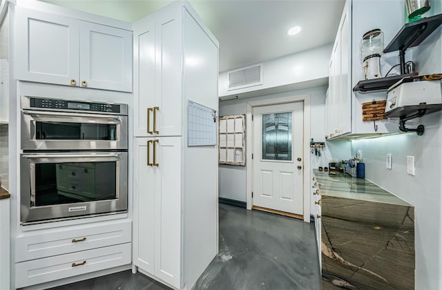 kitchen featuring white cabinetry and double oven