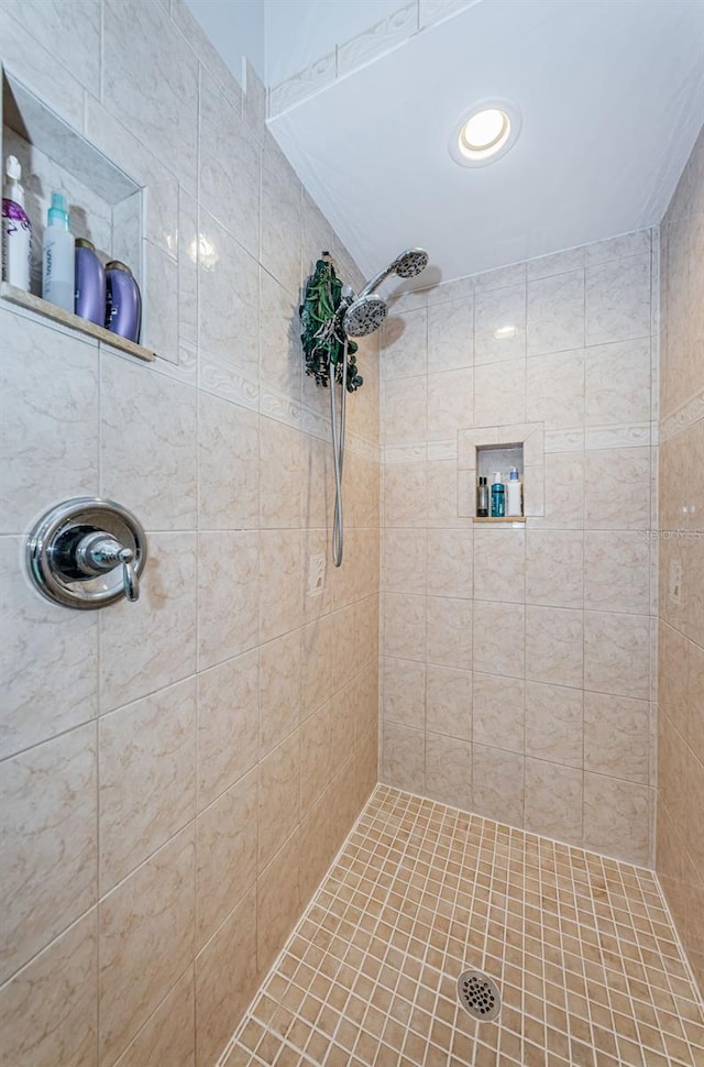 bathroom with tiled shower