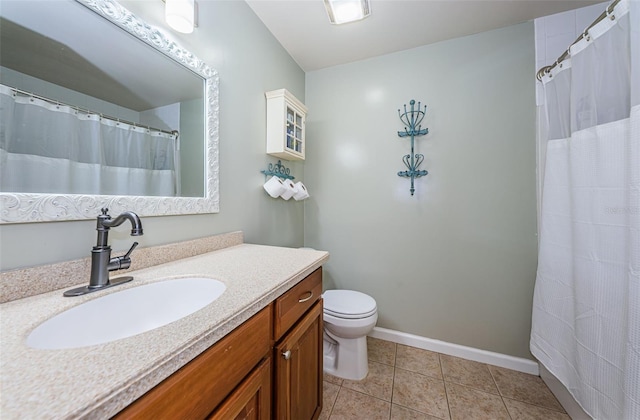 bathroom featuring vanity, toilet, and tile patterned flooring