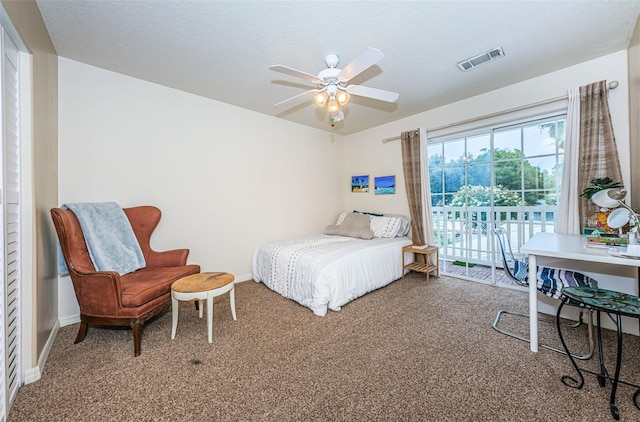 bedroom with access to exterior, ceiling fan, a textured ceiling, and carpet