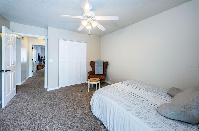 bedroom featuring ceiling fan, a closet, a textured ceiling, and dark colored carpet