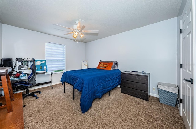 carpeted bedroom with ceiling fan and a textured ceiling