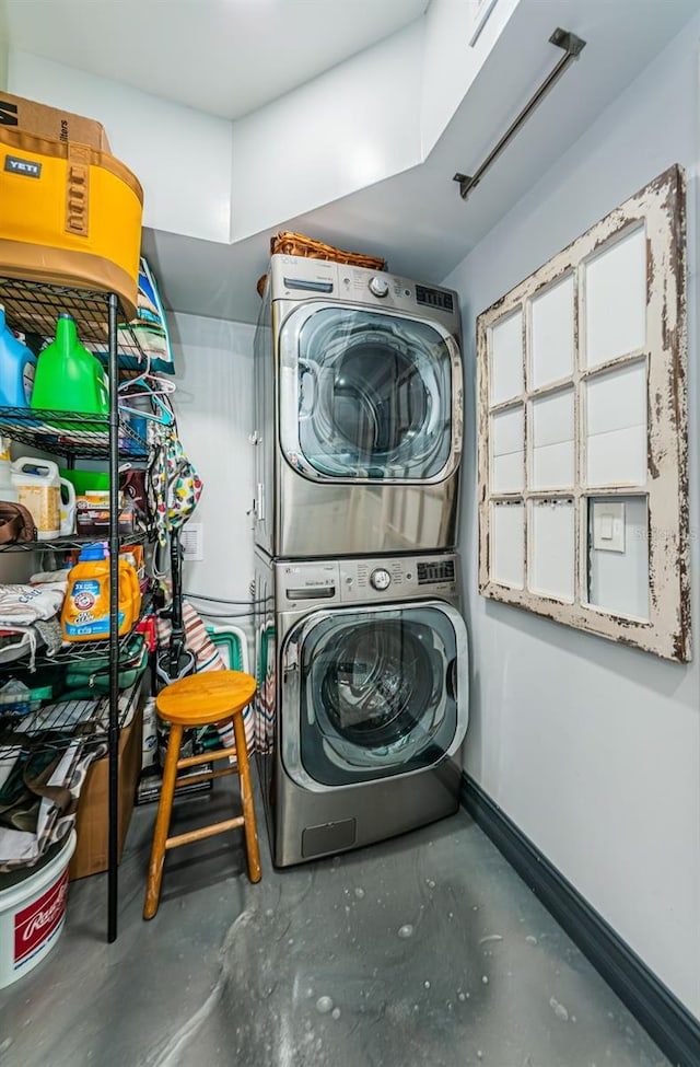 washroom with stacked washing maching and dryer