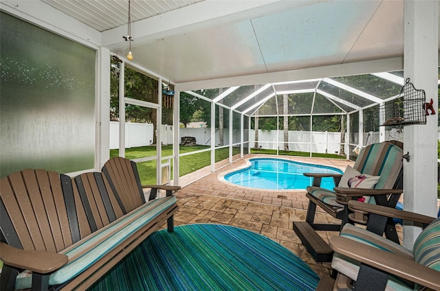 view of pool with a patio, a lanai, and a yard