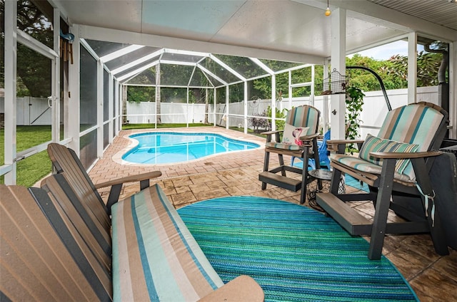 view of swimming pool with a lanai and a patio area