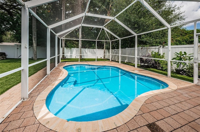 view of pool with a patio area, a shed, and a lawn