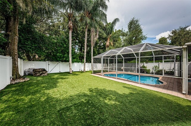 exterior space featuring a lawn and glass enclosure