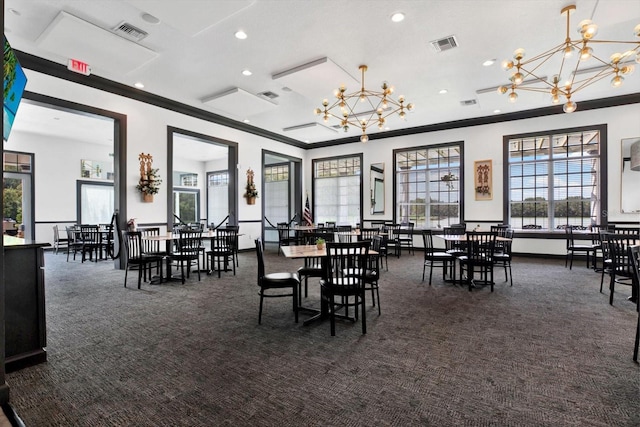 dining room featuring dark carpet, crown molding, and a notable chandelier