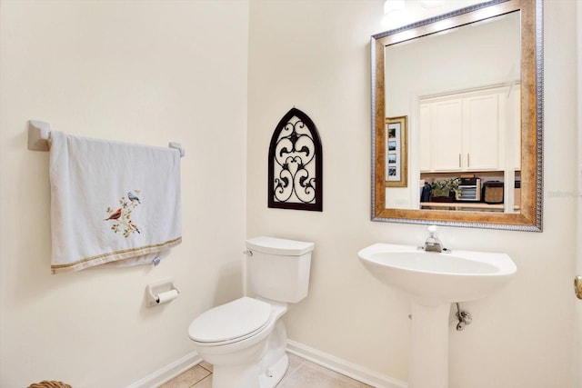 bathroom featuring toilet and tile patterned floors