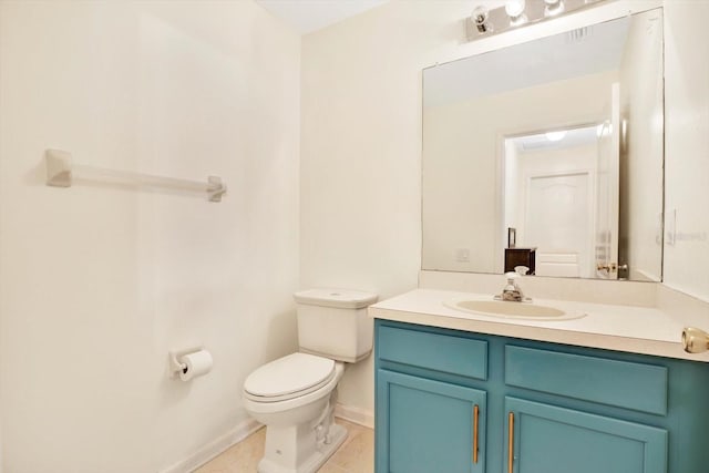 bathroom with tile patterned flooring, toilet, and vanity