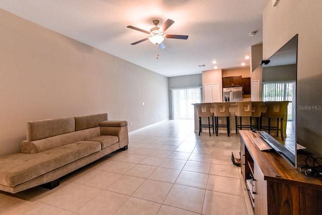 living room with light tile patterned flooring and ceiling fan