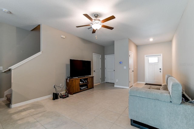 tiled living room featuring ceiling fan