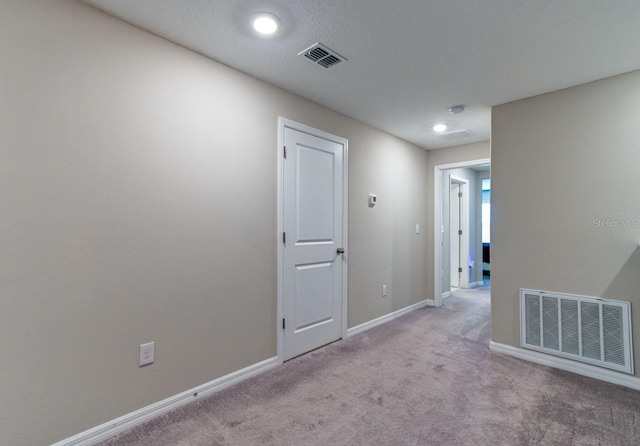 hall featuring carpet flooring