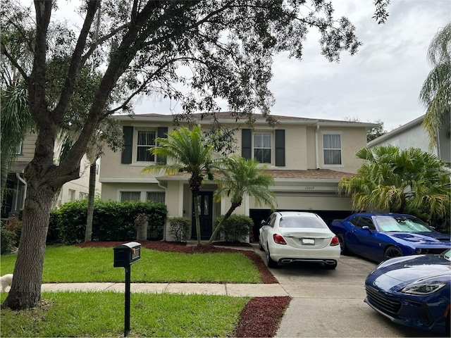 view of front of property with a garage and a front lawn