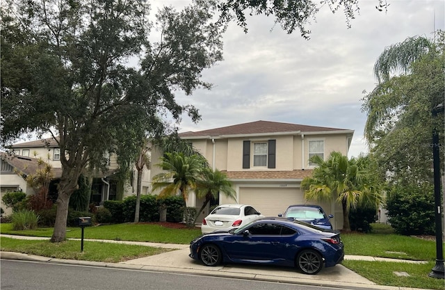 view of front of house featuring a garage and a front lawn