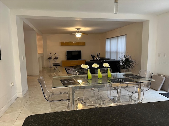 tiled dining room featuring ceiling fan