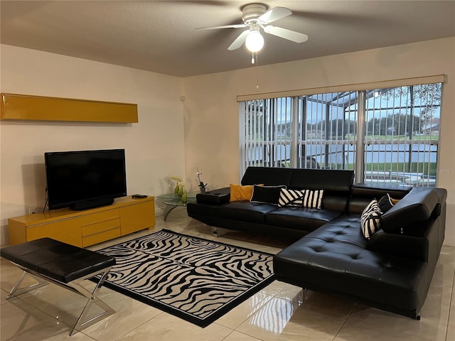 living room with a water view and ceiling fan