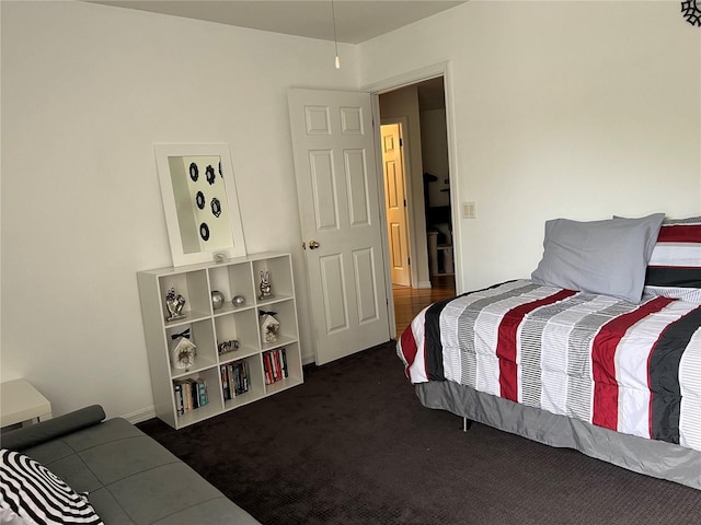 bedroom with dark colored carpet