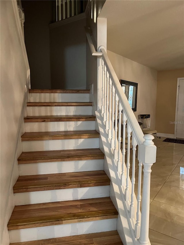 stairway with tile patterned flooring