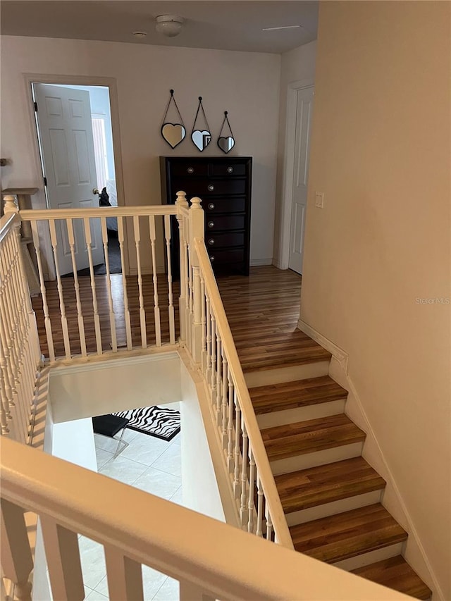 stairway featuring tile patterned flooring