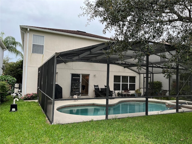 rear view of house with a patio, a lanai, and a yard