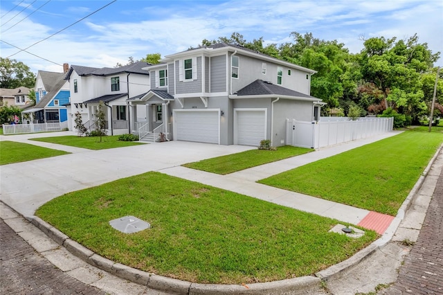 view of property featuring a garage and a front yard