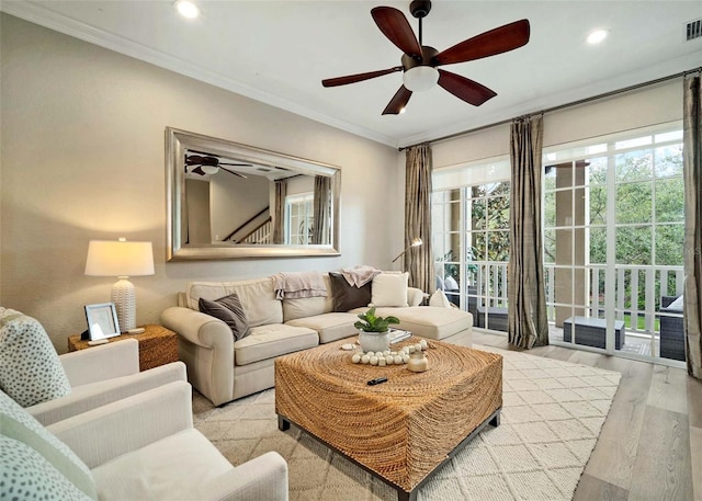 living room featuring ornamental molding and light hardwood / wood-style floors